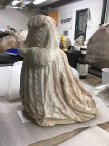 Kneeling figure with hand position for prayer from the tomb of Sir John and Lady Monson in South Carlton church, Lincolnshire