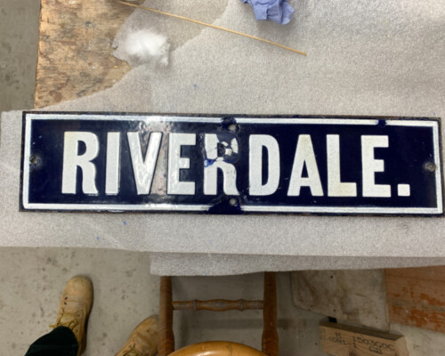 Blue enamel street sign from Horncastle, during conservation Blue enamel street sign from Horncastle, during conservation