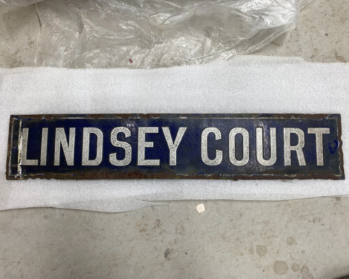 Blue enamel street sign from Horncastle, during conservation Blue enamel street sign from Horncastle, during conservation