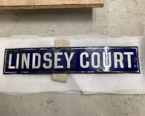 Blue enamel street sign from Horncastle, during conservation Blue enamel street sign from Horncastle, during conservation