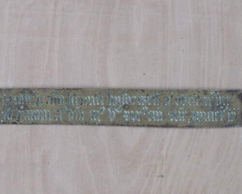 Monumental brass inscription, before conservation