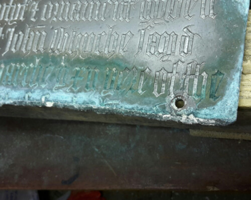 Detail from deteriorated monumental brass from Great Berkhamsted church, Hertfordshire, before conservation