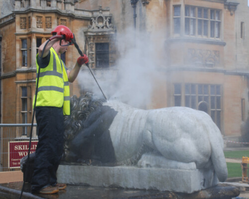 Steam cleaning lion statuary at Harlaxton Manor, Lincolnshire. Steam cleaning lion statuary at Harlaxton Manor, Lincolnshire.