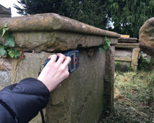 Churchyard survey using tools to identify metal content. Churchyard survey using tools to identify metal content.