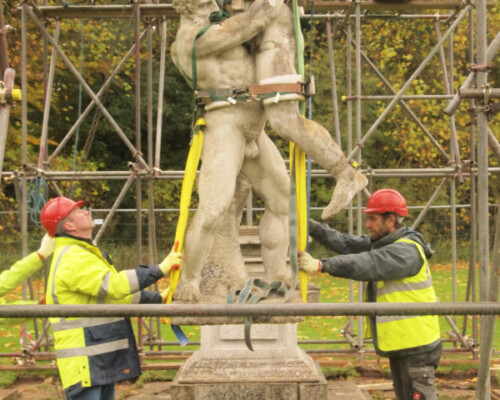 Lifting the Hercules wrestling Anateus sculpture at Anglesey Abbey for conservation.